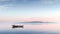 Boat on a calm blue lake with blue sky