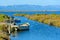 Boat on a Canal in Ebro Delta estuary and wetlands, Tarragona, Catalunya, Spain.