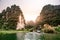 Boat cave tour in Trang An Scenic Landscape formed by karst towers and plants along the river (UNESCO World Heritage Site). It\'s