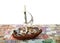 Boat with coins on background of banknotes of different countries