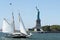 Boat cruises in the ocean with the iconic Statue of Liberty in the backdrop in the United States