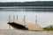 A boat dock along side a freshwater lake