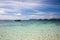 boat on an emerald blue beach