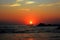 Boat with fishermen on the background of the sunset on the sea.