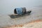 Boat of fishermen stranded in the mud at low tide on the river Malta near Canning Town, India