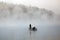 Boat fishing in the fog