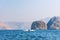 Boat floating on seaside surrounded by desert rocks near Khasab