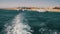 Boat is Floating on the Waves and Leaves a Trail in the Red Sea