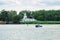 The boat floats on the Don River against the background of the old building of the Pilots` Station