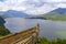 A boat in the foreground and a view of the lake and mountains in nature