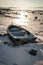 Boat frozen in fjord in winter sunshine