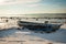 Boat frozen in fjord in winter sunshine