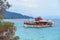 A boat full of tourists in one of the bays of the beach with rock formations of Karidi, in Greece