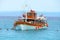 A boat full of tourists in one of the bays of the beach with rock formations of Karidi, in Greece