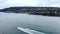 A boat is heading out of Vancouver Harbour with West Vancouver in the background