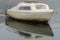 A boat in heavy sea fret at the harbour, at high tide in Seaton Sluice, Northumberland, UK