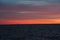 Boat at the horizon on wide river at sunrise