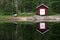 Boat house reflecting on lake