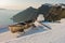 Boat on a house roof at sunset in front of Skaros rock at Imerovigli village, Santorini island