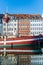 boat and houses reflected in water at Nyhavn pier, copenhagen, denmark