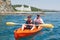 Boat kayaking near cliffs on a sunny day. Kayaking in a quiet bay. Amazing views. Travel, sports concept. Lifestyle. A