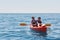 Boat kayaking near cliffs on a sunny day. Kayaking in a quiet bay. Amazing views. Travel, sports concept. Lifestyle. A