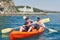 Boat kayaking near cliffs on a sunny day. Kayaking in a quiet bay. Amazing views. Travel, sports concept. Lifestyle. A