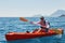 Boat kayaking near cliffs on a sunny day. Travel, sports concept. Lifestyle