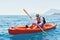 Boat kayaking near cliffs on a sunny day. Travel, sports concept. Lifestyle