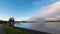 Boat on the lake surface in New Zealand with an asphalt road near it