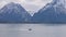 Boat and Lake surrounded by Trees and Mountains in American Landscape