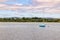 Boat in Lough Corrib with forest and farm fields in background