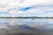 Boat in Lough Corrib with forest and farm fields in background