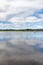 Boat in Lough Corrib with forest and farm fields in background