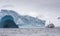 Boat in a middle of massive glaciers off the coast of Antarctic Peninsula