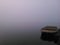 Boat on Milada lake post mining lake recultivated coal mine lake in haze