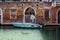 A boat moored near an old brick wall in Venice