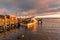 Boat moored to a jetty at sunset