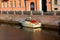 Boat moored at the wall of the embankment on the canal in St. Petersburg