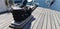 Boat mooring bollard with black rope, wooden deck