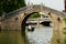 Boat navigating Bridge on Canal, Zhouzhuang, China