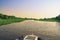 Boat navigating through flooded waters of Pantanal at sunset