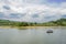 Boat oaring in lake on cloudy spring day