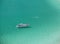 Boat over a crystalline turquoise beach