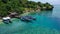 A boat parked next to the shore on Menjangan Island, Bali, Indonesia. Boats parked on a coral reef in the sea. Beautiful