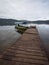 Boat passenger ship vessel waiting at idyllic Amazon rainforest jungle river lake wooden jetty dock pier Tarapoto Peru