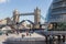 Boat passes through Tower Bridge\'s open drawbridge