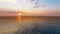 A boat passing by near a beach against beautiful sunset and calm sea