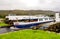 A boat passing through the opend swing bridge and entering the Caledonian Canal from Loch Oich near Aberchalder, Scotland