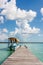 Boat at the pier with clouds and blue water at the Laguna Bacalar, Chetumal, Quintana Roo, Mexico.